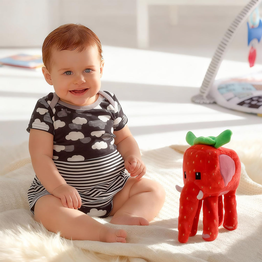 Side view of the Strawberry Elephant plush showing the pink elephant ear and boxy red strawberry body